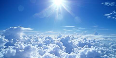 Bright sun shining over a sea of fluffy white clouds against a vibrant blue sky