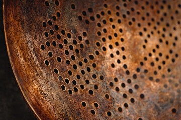 Rustic Brown Metal Colander with Holes Texture Background