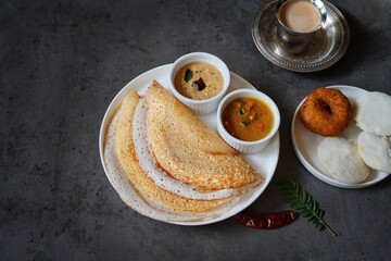 Homemade Triangle Dosa served with chutney sambar idli and vada | South Indian vegetarian breakfast