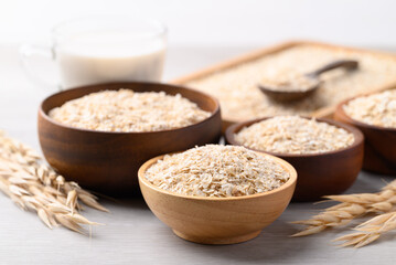 Oat flakes in bowl and oat milk on white background, Alternative milk made from plant, non dairy