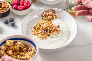 Greek yogurt with granola, fresh Berries and nuts. A quick and healthy breakfast concept
