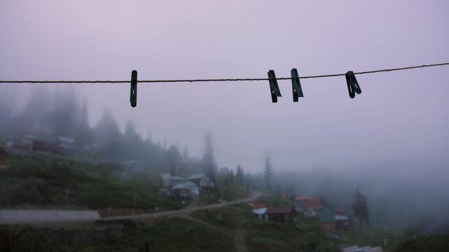 Empty clothesline with clothespins in the village