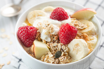 Healthy breakfast, muesli with flakes and fresh fruits, Close-up