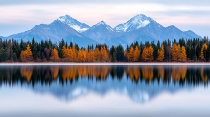 Obraz premium Serene autumn landscape with snow-capped mountains reflected in a calm lake.