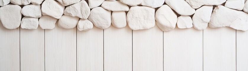 A serene wall design featuring smooth white stones atop a light wooden panel background, creating a calm, natural aesthetic.