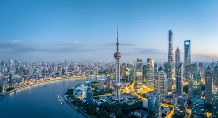 Selbstklebende Fototapeten Aerial view of Shanghai city skyline with river at night view © zhao dongfang