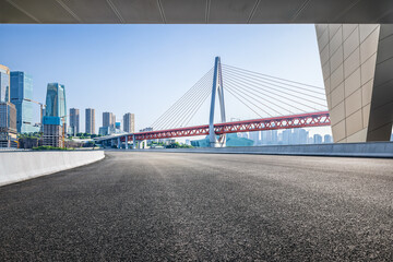 Empty asphalt road with Chongqing city and bridge background