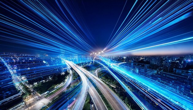 aerial view of city streets at night with vibrant blue light trails from cars creating a dynamic and futuristic atmosphere