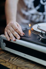 DJ adjusting turntable settings, capturing the artistry of live music mixing and performance