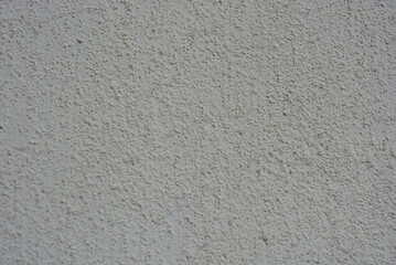 Architecture, construction, construction works. Beautiful cement walls covered with white primer with stones and roughness.