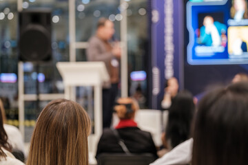 Attendees focus on speaker during a corporate conference in a modern setting. Engaging atmosphere fosters knowledge sharing and networking among professionals Ideal for business and educational themes