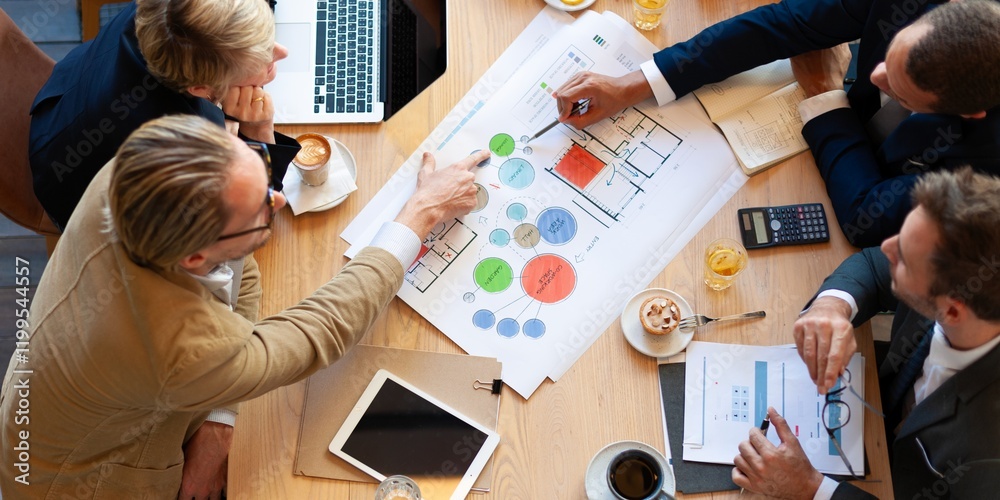 Aufkleber Business meeting with diverse team analyzing charts and plans. Professionals discussing strategy. Teamwork and collaboration in office setting. Diverse business people discussing work.