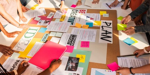 Diverse group collaborating. Hands arranging colorful papers, notes, and plans. Teamwork and...