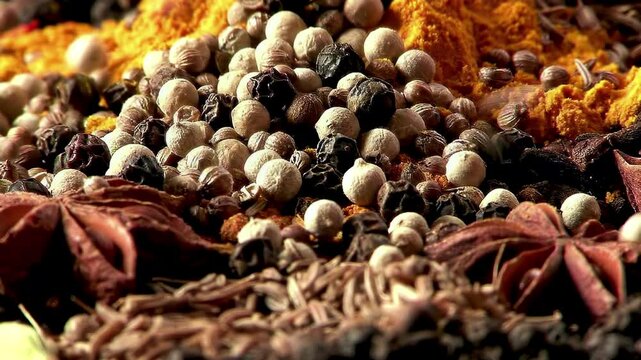 Vibrant Spice Mix: yellow turmeric powder, cumin seeds, black peppercorns, green cardamom pods, and fresh mint leaves.