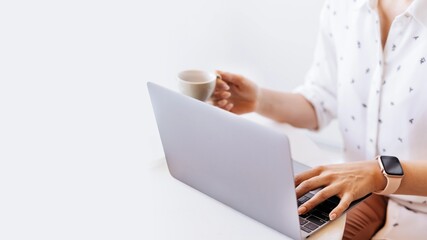 Businesswoman drinking coffee while working at home