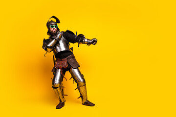 Fototapeta premium Medieval Knight with Sunglasses and Playful Pose on Vibrant Yellow Background