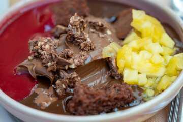 sumptuous melted chocolate desert served with chopped pineapple and raspberry sauce