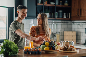 Lesbian couple preparing breakfast in modern kitchen