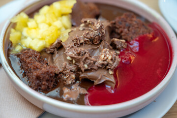 sumptuous melted chocolate desert served with chopped pineapple and raspberry sauce
