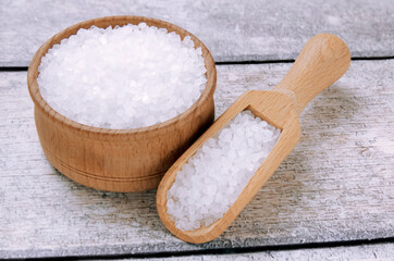 Sea salt on a wooden table. Coarse sea salt for cooking.
