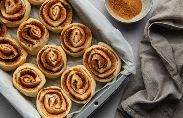 Delicious cinnamon rolls prepared for baking in a rectangular pan
