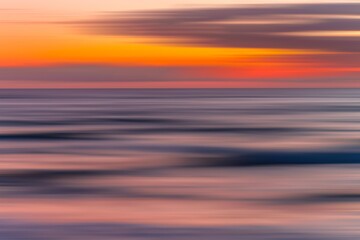 Fototapeta premium A mesmerizing display of colors unfolds across the sky as shades of orange, purple, and magenta blend seamlessly into the white, creating a vibrant chromatic reverie. 