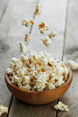 flying popcorn falling in bowl on table
