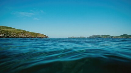 Fototapeta premium Serene Coastal View Green Hills and Blue Water
