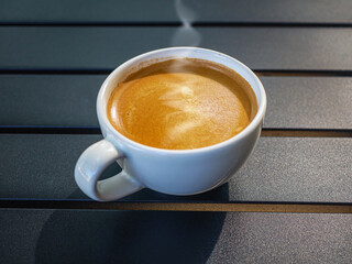 Coffee cream texture of fragrant coffee in a cup with delightful coffee foam. Top view coffee crema