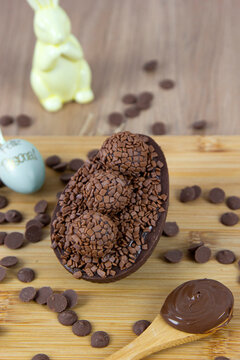 Chocolate Easter egg filled with chocolate ganache. Easter egg with brigadeiro. (Contains the phrase "Happy Easter" in Brazilian Portuguese on the decorative green Easter egg.)