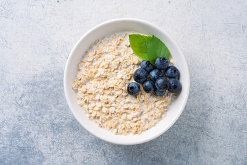 Milk porridge prepared for breakfast with blueberries, strawberries and bananas