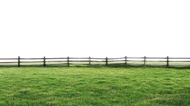 Lush green grass field with a rustic wooden fence against a dark background, perfect for nature-themed projects.