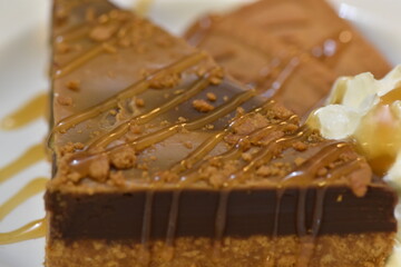 Biscoff Biscuit Cake, a delectable fusion of flavors and textures that is sure to captivate the senses. This three-tiered masterpiece features layers of moist, rich cake.