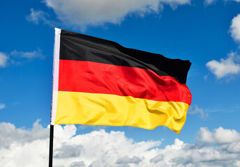 German flag waving against blue sky