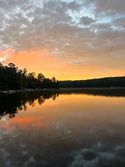 Fototapeten Serene Sunset Over Calm Lake with Vibrant Reflections © Jonathan