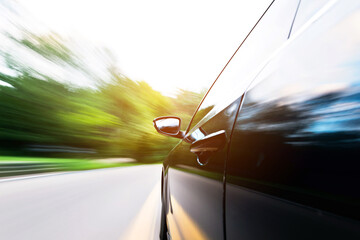 Car in motion blur driving in the forest