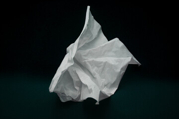 used tissue crumpled isolated on black
