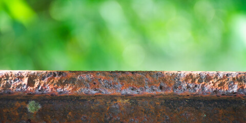 rusty iron for product placement with blured fresh green plant background
