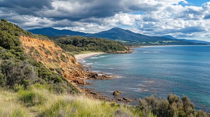 Obraz premium Coastal Landscape Featuring Cliffs Beach and Mountains
