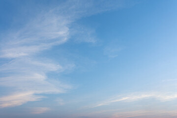 The vast blue sky, adorned with fluffy white clouds, showcases the beauty of nature on a sunny summer day