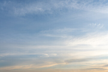 The dramatic cloudscape at sunset paints the sky with hues of orange, red, and purple, casting a mesmerizing glow across the landscape