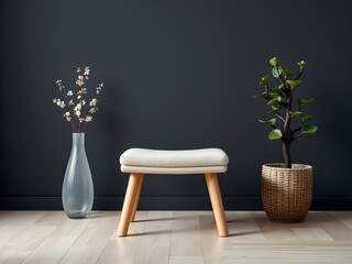 Modern Minimalist Interior Design: A soft,  white ottoman with wooden legs takes center stage against a dark, charcoal wall. Simple elegance is captured with minimalist styling.