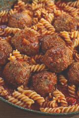 minced meat meatballs, in tomato sauce, with fusilli pasta, in a cast-iron pan, homemade, no people,