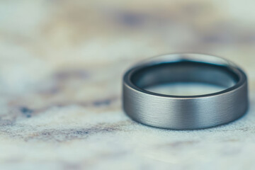 close up of brushed silver ring with matte finish, showcasing its elegant design and smooth texture