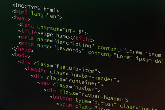 Html code as coding and programming language concept. Source code and script with colorful elements on dark background, tilted angle and view.