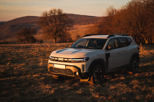 SASCHIZ, ROMANIA - DECEMBER 30, 2024: New Dacia Duster 4x4 sport urban vehicle on offroad hill at sunset.