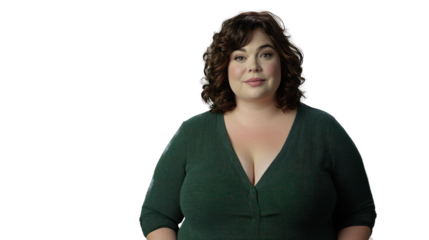 Confident woman with curly hair wearing a green sweater, standing against a white isolated background, exuding positivity and empowerment.