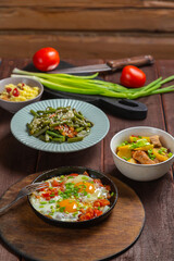 Set table, Jewish food, tzimmes, chelnt, shakshuka and couscous