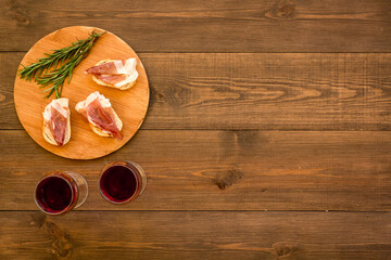 Antipasti - prosciutto ham and glass of wine. Traditional Spanish meal