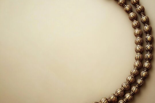 close-up of tasbih prayer beads arranged in circular pattern on smooth beige background